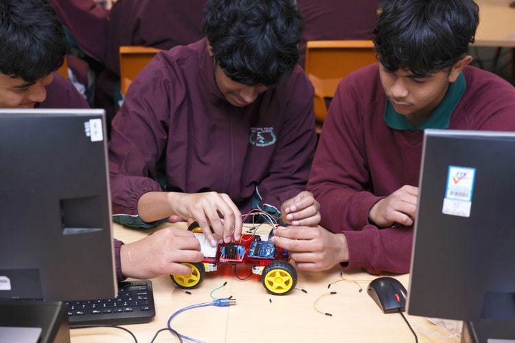 Two students working on constructing a programmable car