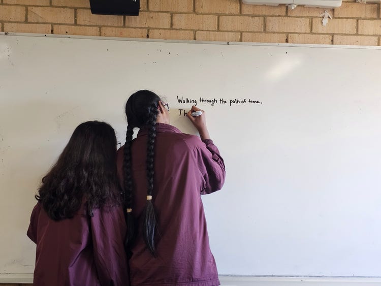 Students drafting a poem in Poetive Arts on a whiteboard