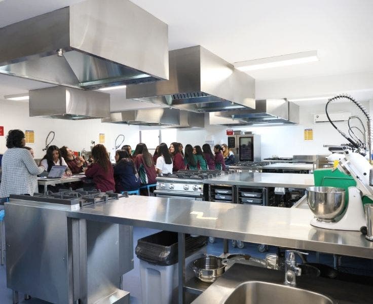 Class in progress in a stainless steel industrial kitchen