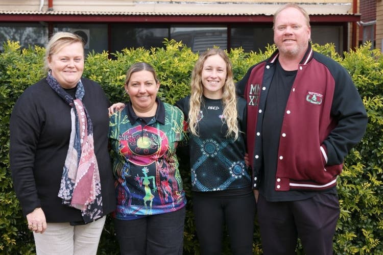 4 members of the learning and wellbeing staff standing in a group