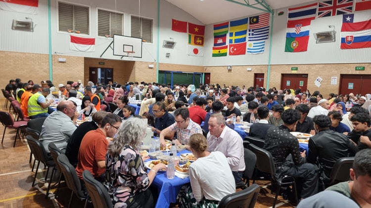 Parents and staff sharing the Iftar meal together at many tables